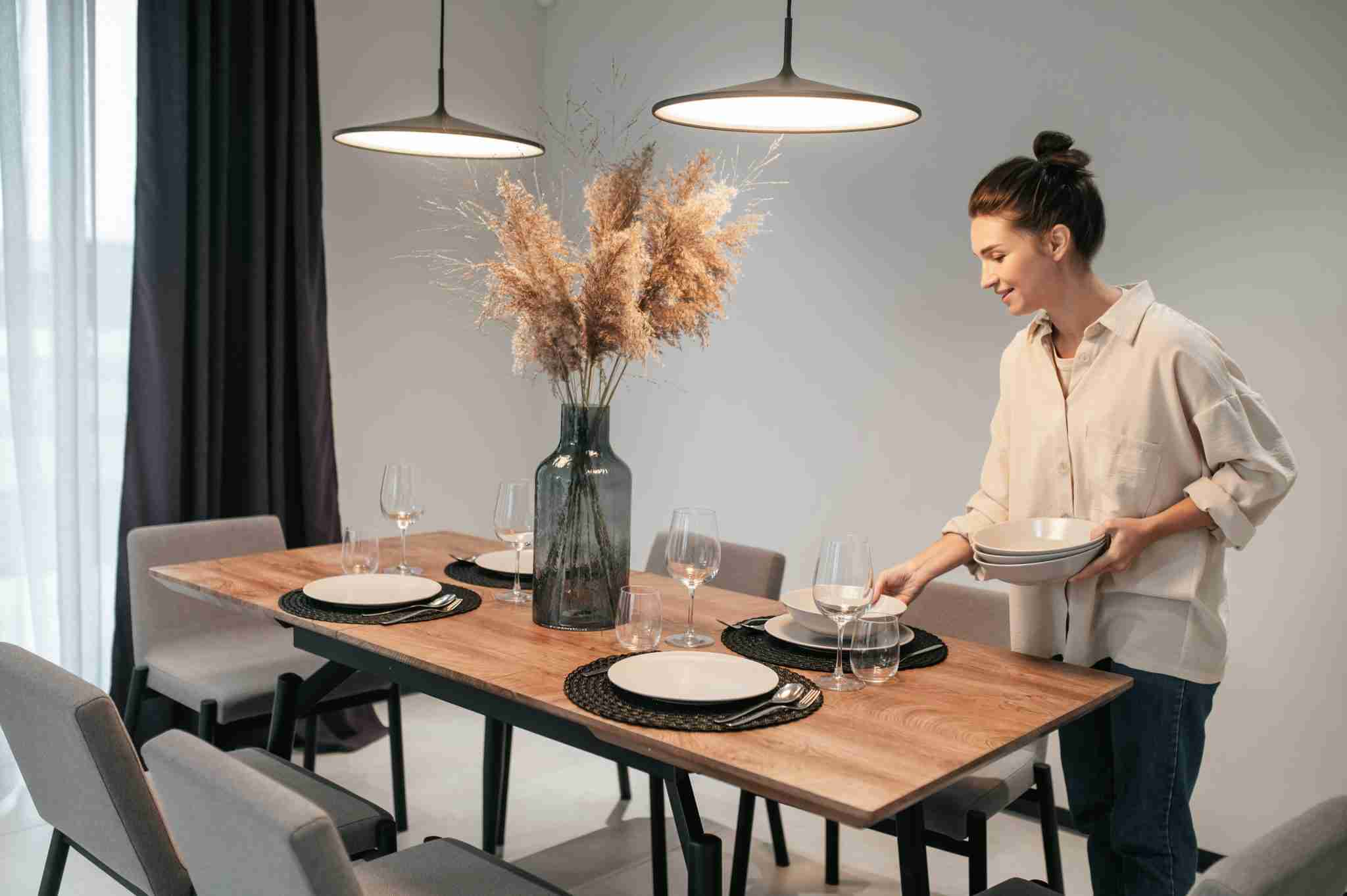 Woman styling a table setting in a kitchen